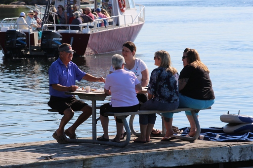 A group enjoys breakfast on the dock